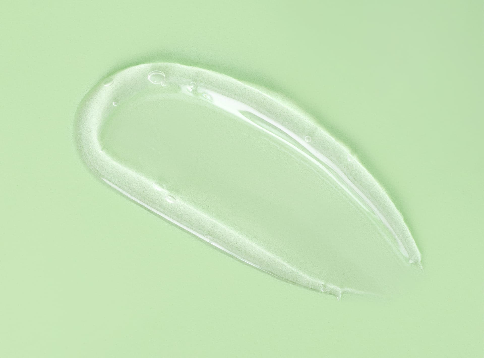 Clear hydrating gel swatch on a soft green background
