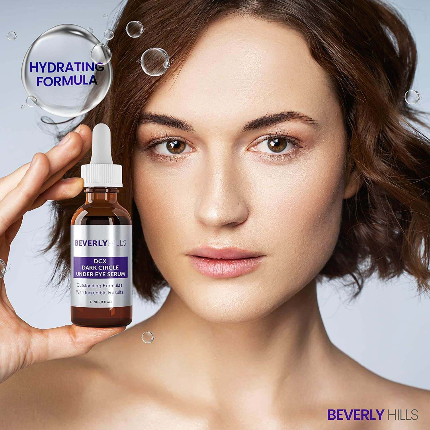 Model holding the DCX Under Eye Serum, hydrating formula