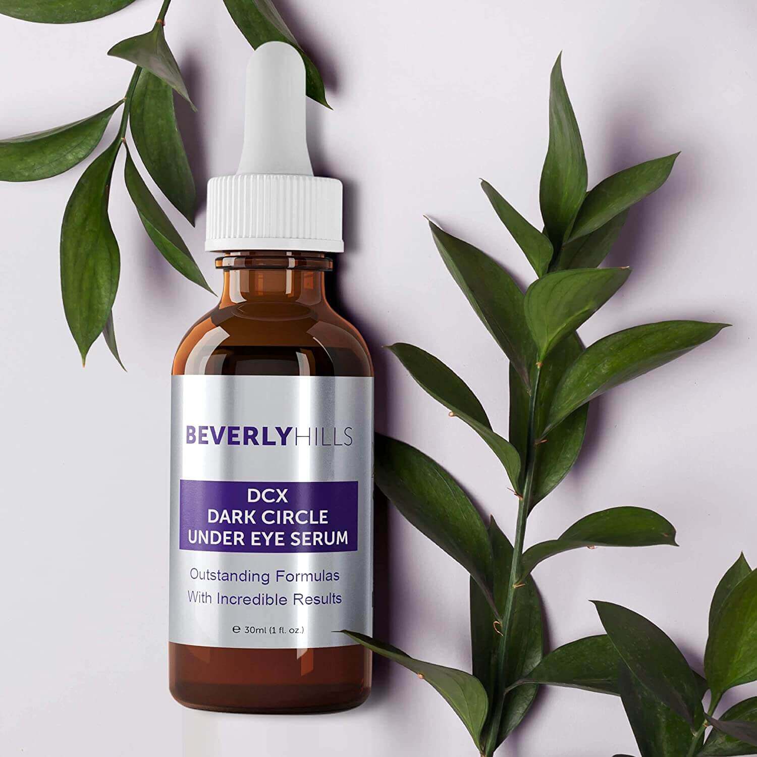 DCX Under Eye Serum bottle flat lay with botanical leaves