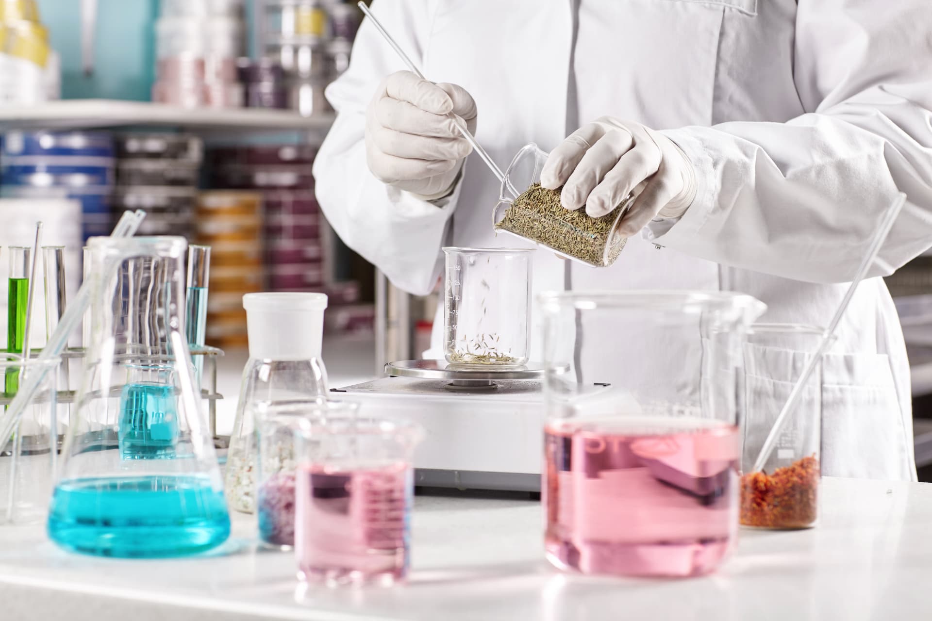 Cosmetic chemist weighing botanical actives at a laboratory bench