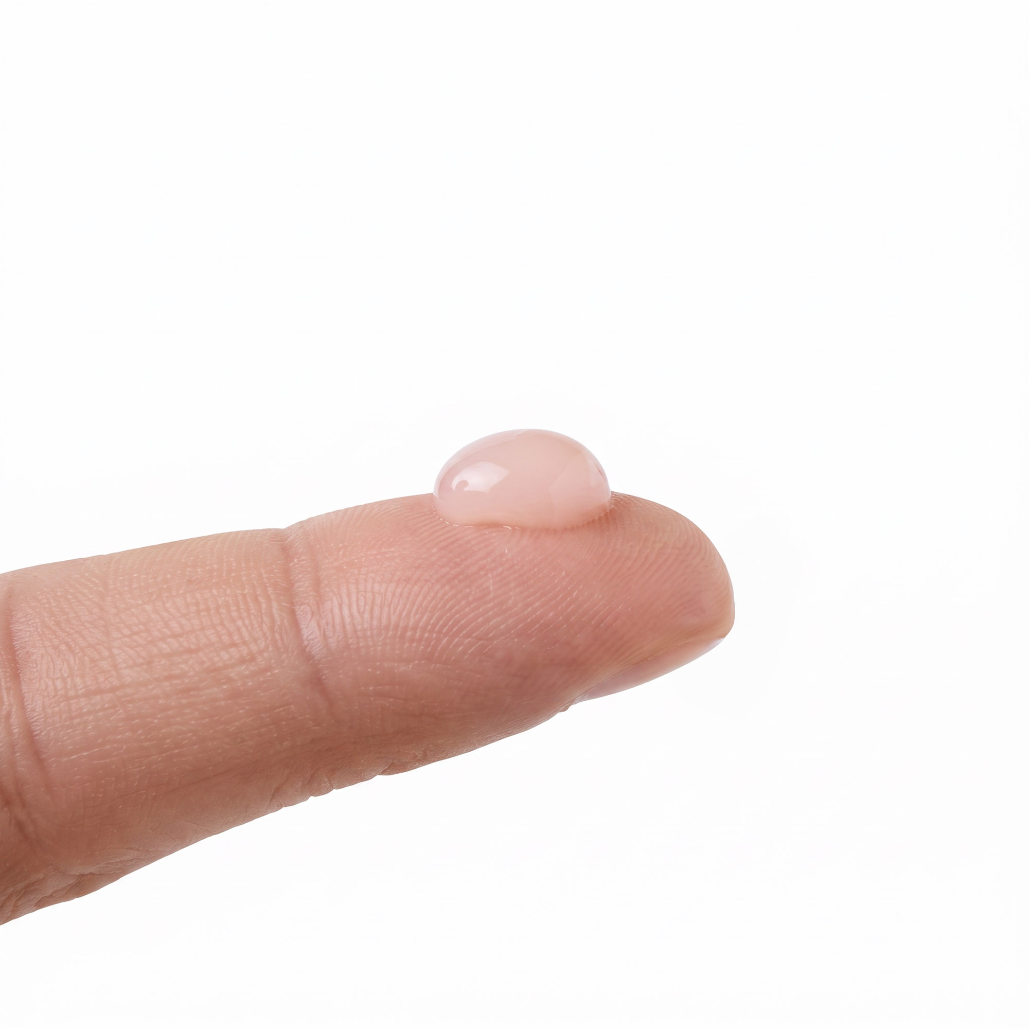 A pea-sized amount of Instant Facelift serum on a fingertip, showing how little you need